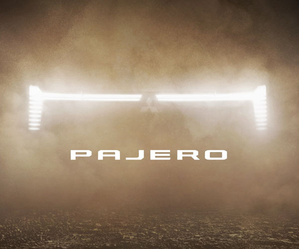 Pajero headlights and text showing through a dust cloud