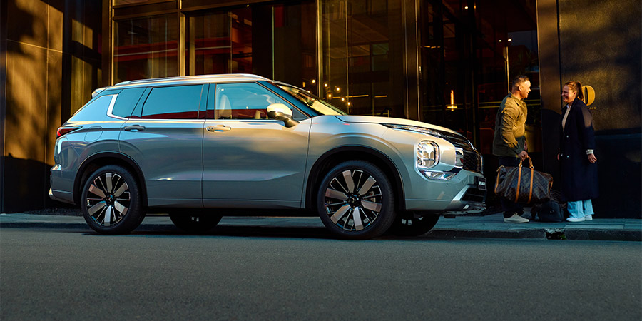 A Grey Mitsubishi SUV parked outside a hotel